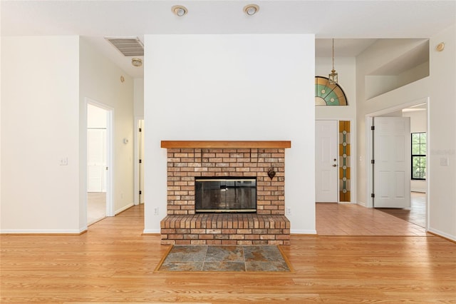 9180 SW 202nd Avenue Rd, Dunnellon, FL 34431 - unfurnished living room with wood finished floors and a fireplace
