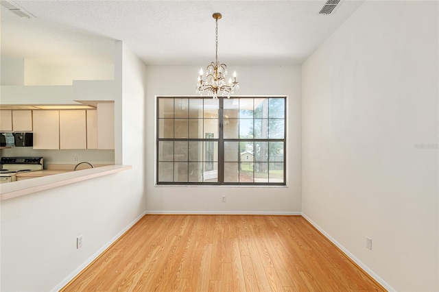9180 SW 202nd Avenue Rd, Dunnellon, FL 34431 - unfurnished dining area with light wood-style flooring and a chandelier
