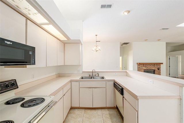 9180 SW 202nd Avenue Rd, Dunnellon, FL 34431 - kitchen with white appliances, a peninsula, a chandelier, and light countertops