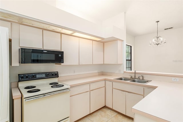 9180 SW 202nd Avenue Rd, Dunnellon, FL 34431 - kitchen featuring black microwave, white electric range oven, cream cabinets, a chandelier, and light countertops