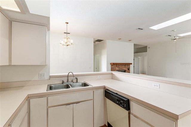 9180 SW 202nd Avenue Rd, Dunnellon, FL 34431 - kitchen with dishwasher, a skylight, a brick fireplace, light countertops, and open floor plan