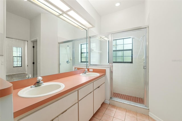 9180 SW 202nd Avenue Rd, Dunnellon, FL 34431 - bathroom featuring a stall shower, double vanity, and tile patterned flooring