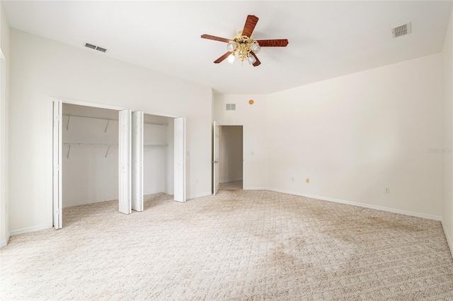 9180 SW 202nd Avenue Rd, Dunnellon, FL 34431 - unfurnished bedroom with multiple closets, light colored carpet, and a ceiling fan