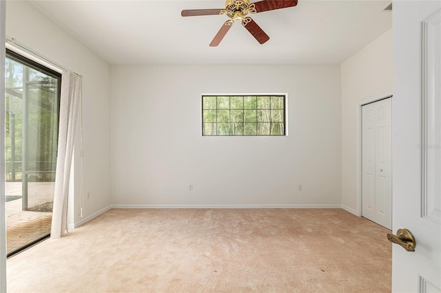 9180 SW 202nd Avenue Rd, Dunnellon, FL 34431 - unfurnished bedroom with access to outside, light colored carpet, and a ceiling fan