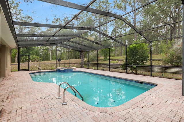 9180 SW 202nd Avenue Rd, Dunnellon, FL 34431 - view of swimming pool featuring a pool with connected hot tub, a patio, and glass enclosure