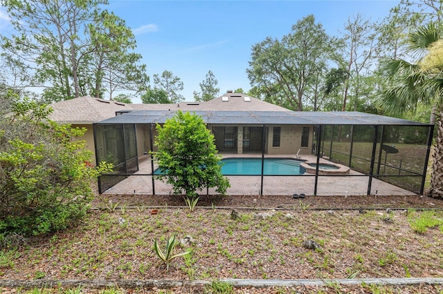 9180 SW 202nd Avenue Rd, Dunnellon, FL 34431 - view of swimming pool with a patio, glass enclosure, and a pool with connected hot tub