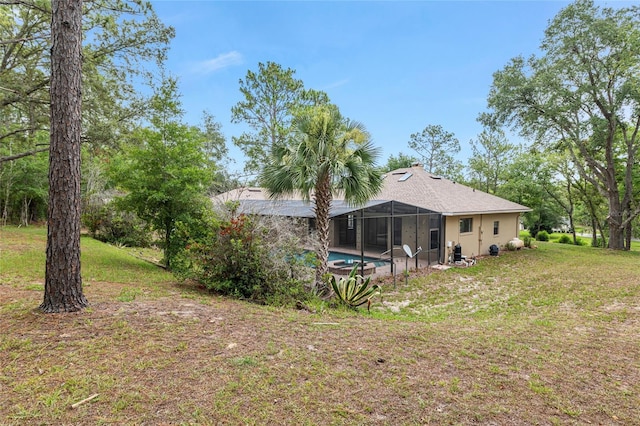 9180 SW 202nd Avenue Rd, Dunnellon, FL 34431 - rear view of property with an outdoor pool, glass enclosure, and a yard
