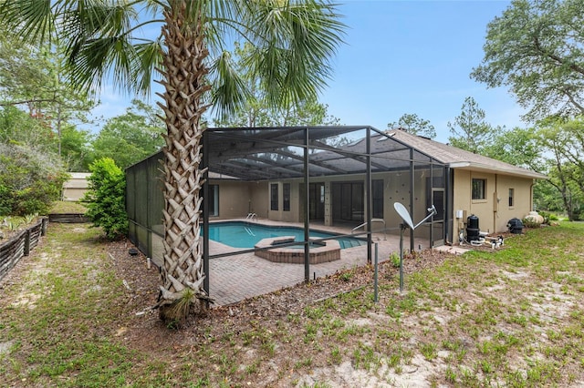 9180 SW 202nd Avenue Rd, Dunnellon, FL 34431 - rear view of property featuring a patio area, stucco siding, and glass enclosure