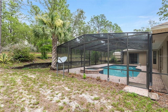 9180 SW 202nd Avenue Rd, Dunnellon, FL 34431 - view of swimming pool with glass enclosure, a patio, and a pool with connected hot tub