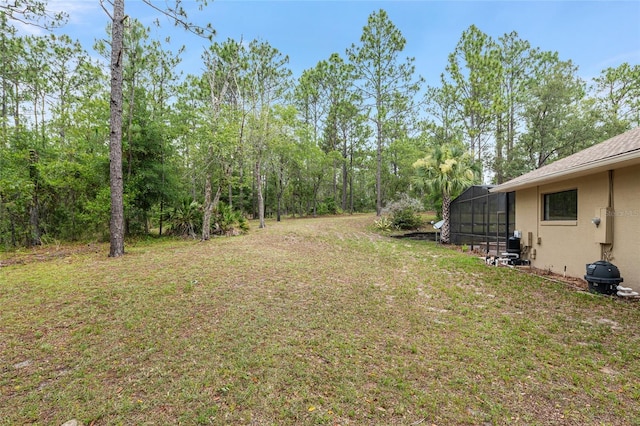 9180 SW 202nd Avenue Rd, Dunnellon, FL 34431 - view of green lawn with glass enclosure