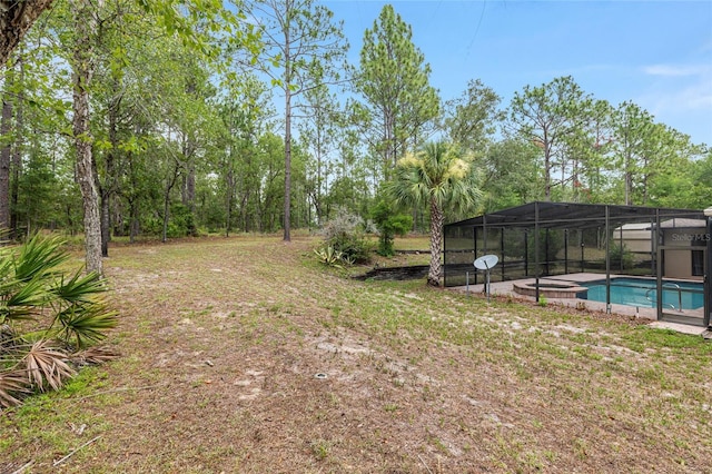 9180 SW 202nd Avenue Rd, Dunnellon, FL 34431 - view of yard featuring glass enclosure and a pool with connected hot tub