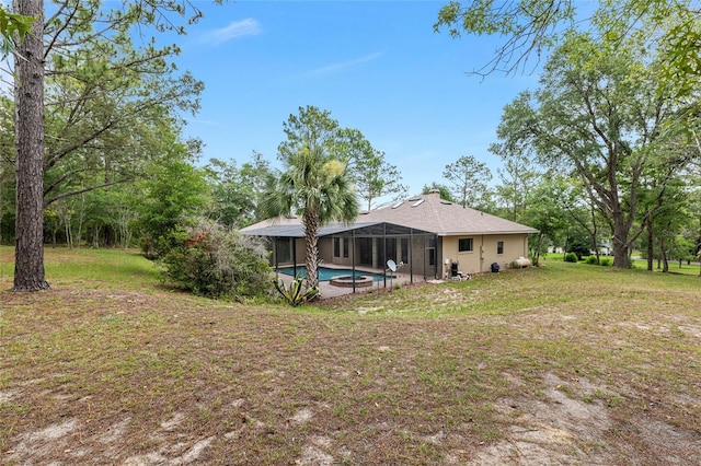 9180 SW 202nd Avenue Rd, Dunnellon, FL 34431 - back of house featuring an outdoor pool, glass enclosure, and a yard