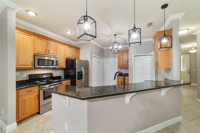 2127 NE 38th Ter, Ocala, FL 34470 - kitchen with stainless steel appliances, ornamental molding, light tile patterned flooring, a breakfast bar, and hanging light fixtures