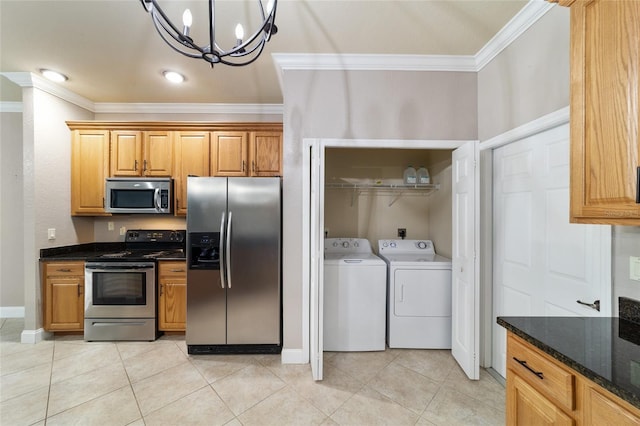 2127 NE 38th Ter, Ocala, FL 34470 - kitchen with appliances with stainless steel finishes, crown molding, separate washer and dryer, a chandelier, and light tile patterned flooring