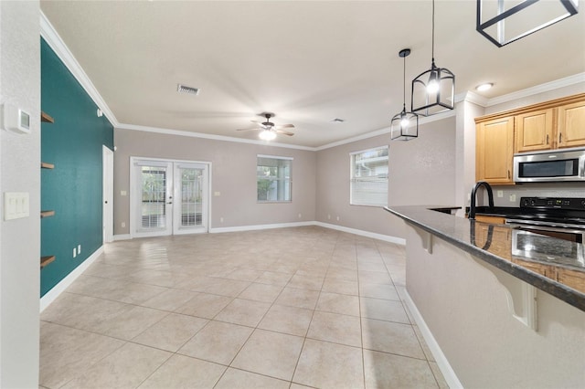 2127 NE 38th Ter, Ocala, FL 34470 - kitchen featuring stainless steel microwave, electric stove, ornamental molding, ceiling fan, and light tile patterned flooring