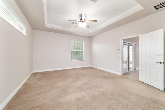 2127 NE 38th Ter, Ocala, FL 34470 - spare room with a raised ceiling, light colored carpet, ornamental molding, and a ceiling fan