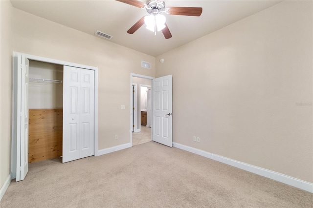 2127 NE 38th Ter, Ocala, FL 34470 - unfurnished bedroom with light carpet, a closet, and a ceiling fan