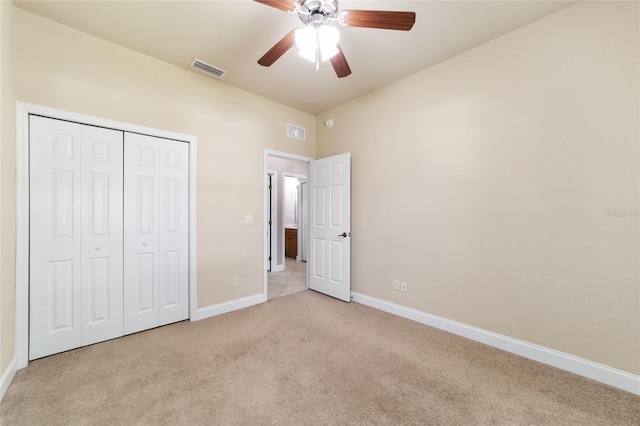 2127 NE 38th Ter, Ocala, FL 34470 - unfurnished bedroom with light colored carpet, a closet, and ceiling fan