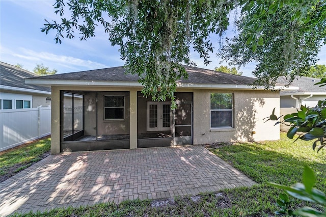 2127 NE 38th Ter, Ocala, FL 34470 - rear view of house featuring stucco siding, french doors, a sunroom, and a patio area