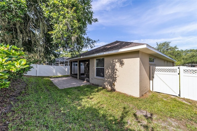 2127 NE 38th Ter, Ocala, FL 34470 - back of house with stucco siding and a fenced backyard