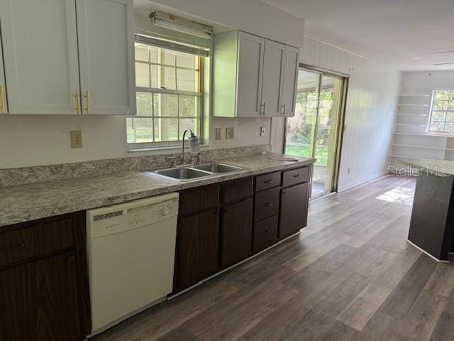 4701 NE 9th St, Ocala, FL 34470 - kitchen with dishwasher, dark wood-type flooring, light countertops, and white cabinetry