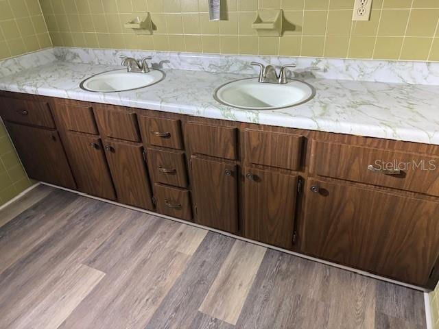 4701 NE 9th St, Ocala, FL 34470 - bathroom with double vanity, wood finished floors, and backsplash