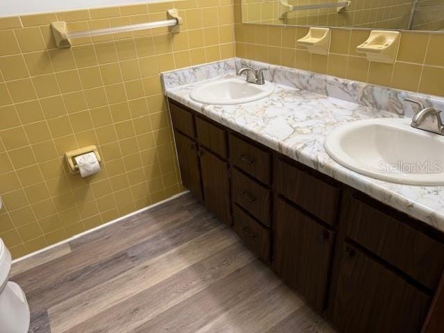 4701 NE 9th St, Ocala, FL 34470 - bathroom with double vanity, wood finished floors, and tile walls