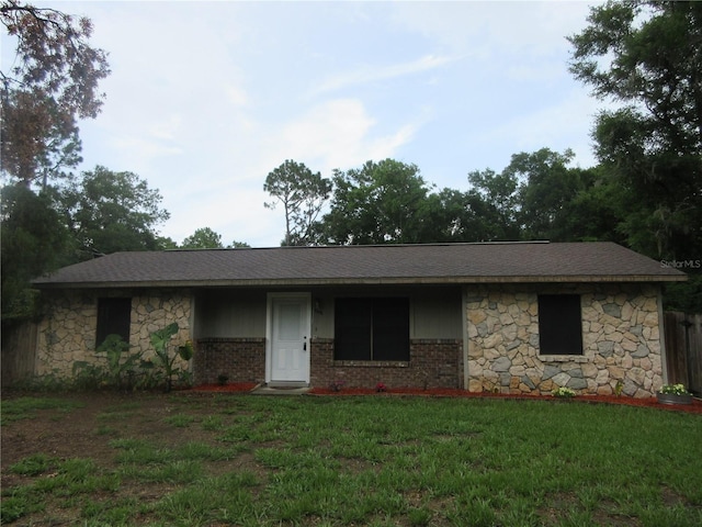 6141 NW 64th Ct, Ocala, FL 34482 - single story home featuring a front yard, stone siding, and brick siding
