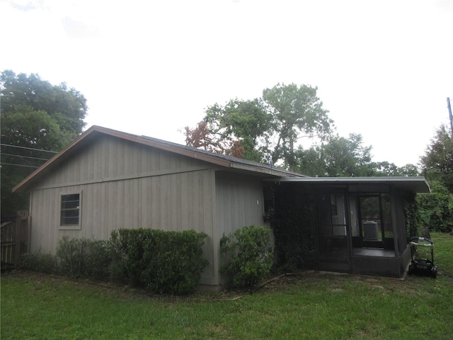 6141 NW 64th Ct, Ocala, FL 34482 - view of property exterior with a lawn and a sunroom