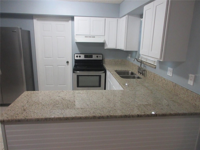 6141 NW 64th Ct, Ocala, FL 34482 - kitchen featuring appliances with stainless steel finishes, under cabinet range hood, light stone counters, and a peninsula