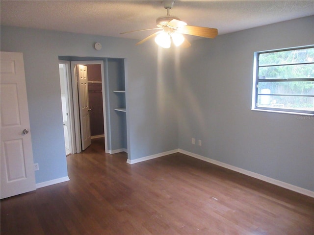 6141 NW 64th Ct, Ocala, FL 34482 - spare room with a ceiling fan, dark wood finished floors, a smoke detector, and a textured ceiling