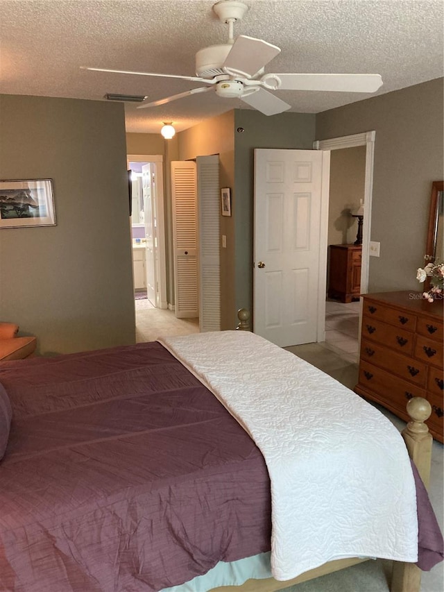 8450 SW 90th St Unit D, Ocala, FL 34481 - bedroom featuring a textured ceiling, ensuite bathroom, and ceiling fan