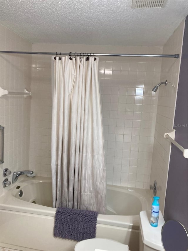 8450 SW 90th St Unit D, Ocala, FL 34481 - bathroom featuring a textured ceiling and shower / bath combo with shower curtain