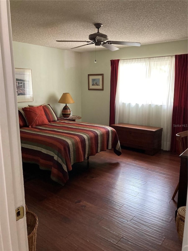 8450 SW 90th St Unit D, Ocala, FL 34481 - bedroom featuring a textured ceiling, hardwood / wood-style floors, and a ceiling fan