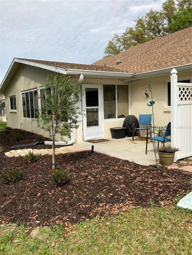 8450 SW 90th St Unit D, Ocala, FL 34481 - back of house featuring a patio area and roof with shingles