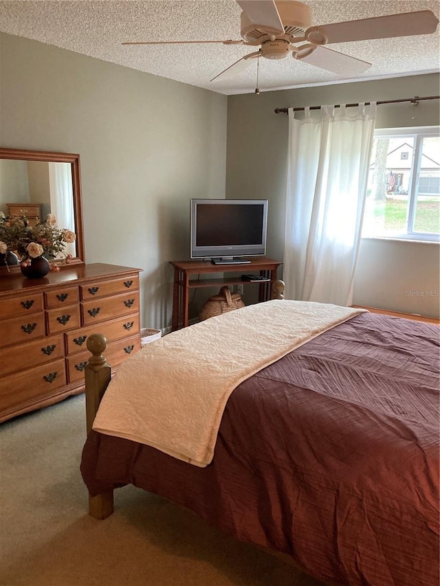 8450 SW 90th St Unit D, Ocala, FL 34481 - carpeted bedroom featuring a textured ceiling and a ceiling fan