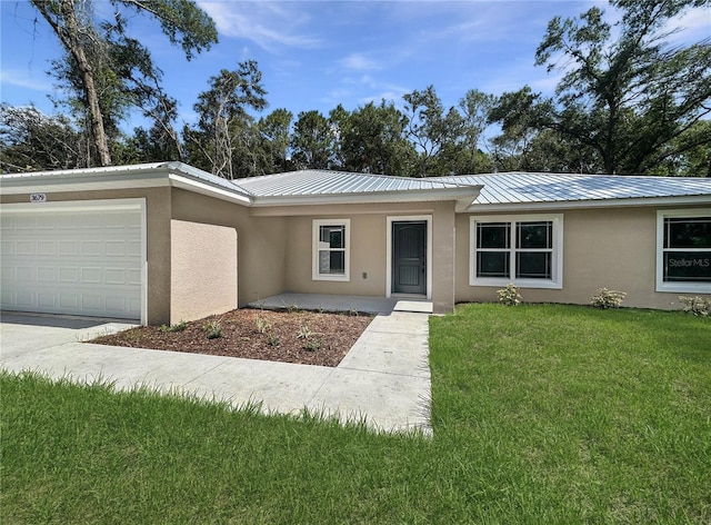 3679 E Bernice St, Inverness, FL 34453 - single story home with stucco siding, an attached garage, a front yard, and a metal roof