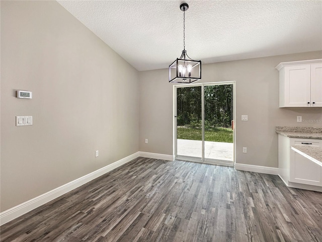 3679 E Bernice St, Inverness, FL 34453 - unfurnished dining area with dark wood-style floors, a chandelier, and a textured ceiling