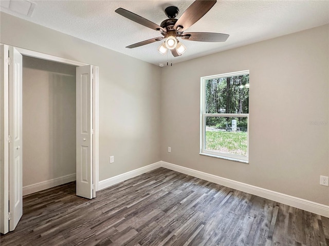 3679 E Bernice St, Inverness, FL 34453 - unfurnished bedroom featuring dark wood-style floors, a ceiling fan, a closet, and a textured ceiling