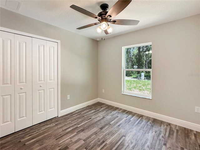 3679 E Bernice St, Inverness, FL 34453 - unfurnished bedroom featuring wood finished floors, a closet, ceiling fan, and a textured ceiling