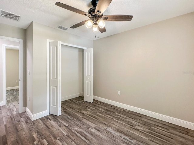 3679 E Bernice St, Inverness, FL 34453 - unfurnished bedroom featuring dark wood-style floors, a closet, ceiling fan, and a textured ceiling