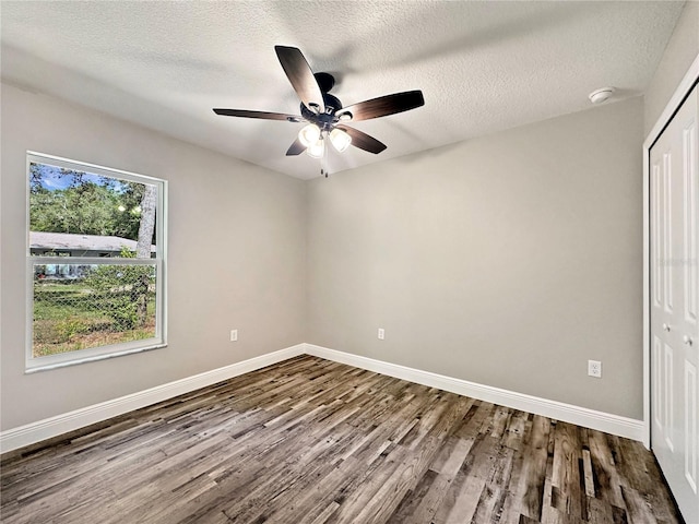 3679 E Bernice St, Inverness, FL 34453 - unfurnished bedroom with a closet, dark wood finished floors, a ceiling fan, and a textured ceiling