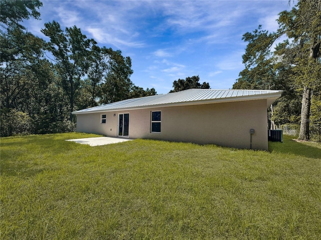 3679 E Bernice St, Inverness, FL 34453 - rear view of property with stucco siding, a patio area, a yard, and a metal roof