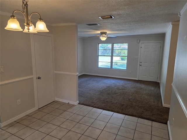315 NE 2nd Ave, Williston, FL 32696 - unfurnished room with light colored carpet, ceiling fan, light tile patterned floors, ornamental molding, and a textured ceiling