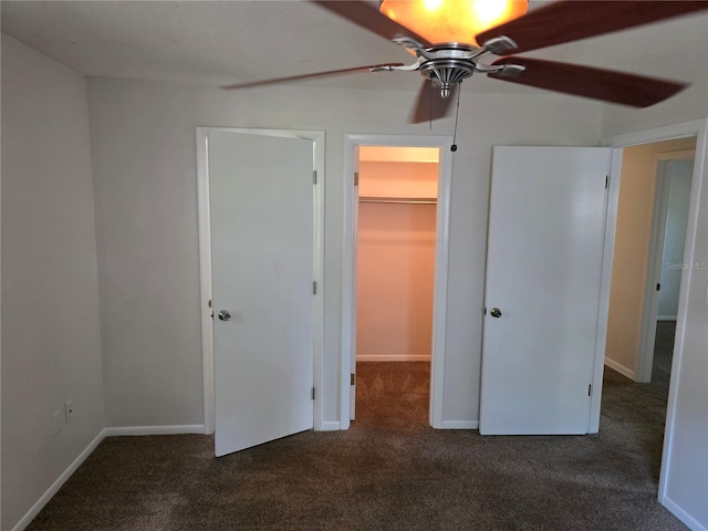 315 NE 2nd Ave, Williston, FL 32696 - unfurnished bedroom featuring carpet floors, a spacious closet, a closet, and a ceiling fan
