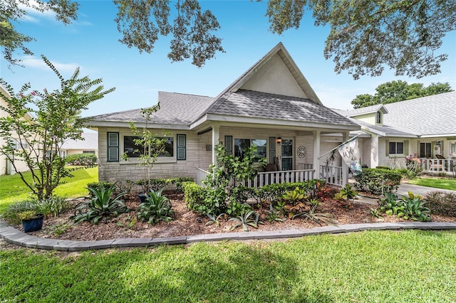 8841 SW 91st St Unit A, Ocala, FL 34481 - view of front of home with a front lawn, a porch, and a shingled roof