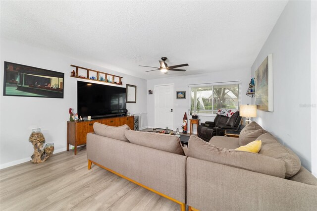 8841 SW 91st St Unit A, Ocala, FL 34481 - living area with light wood-style floors, a ceiling fan, and a textured ceiling