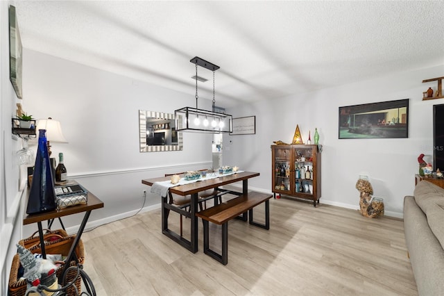8841 SW 91st St Unit A, Ocala, FL 34481 - dining room with light wood finished floors and a textured ceiling
