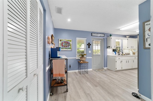 8841 SW 91st St Unit A, Ocala, FL 34481 - foyer entrance with light wood-type flooring and a textured ceiling