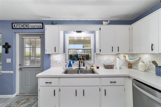 8841 SW 91st St Unit A, Ocala, FL 34481 - kitchen with stainless steel dishwasher, light countertops, tasteful backsplash, and a textured ceiling